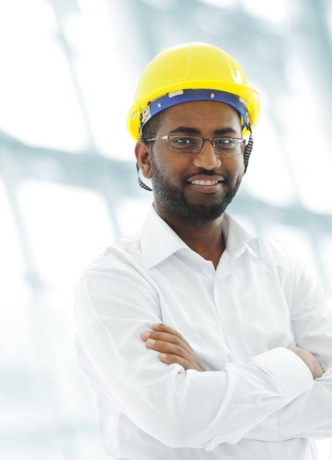 picture of a man wearing a yellow hard hat folding his arms and smiling 