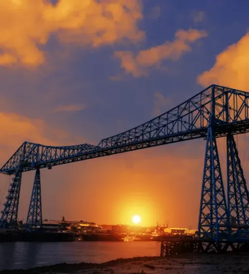 Picture of a bridge with a sunset background