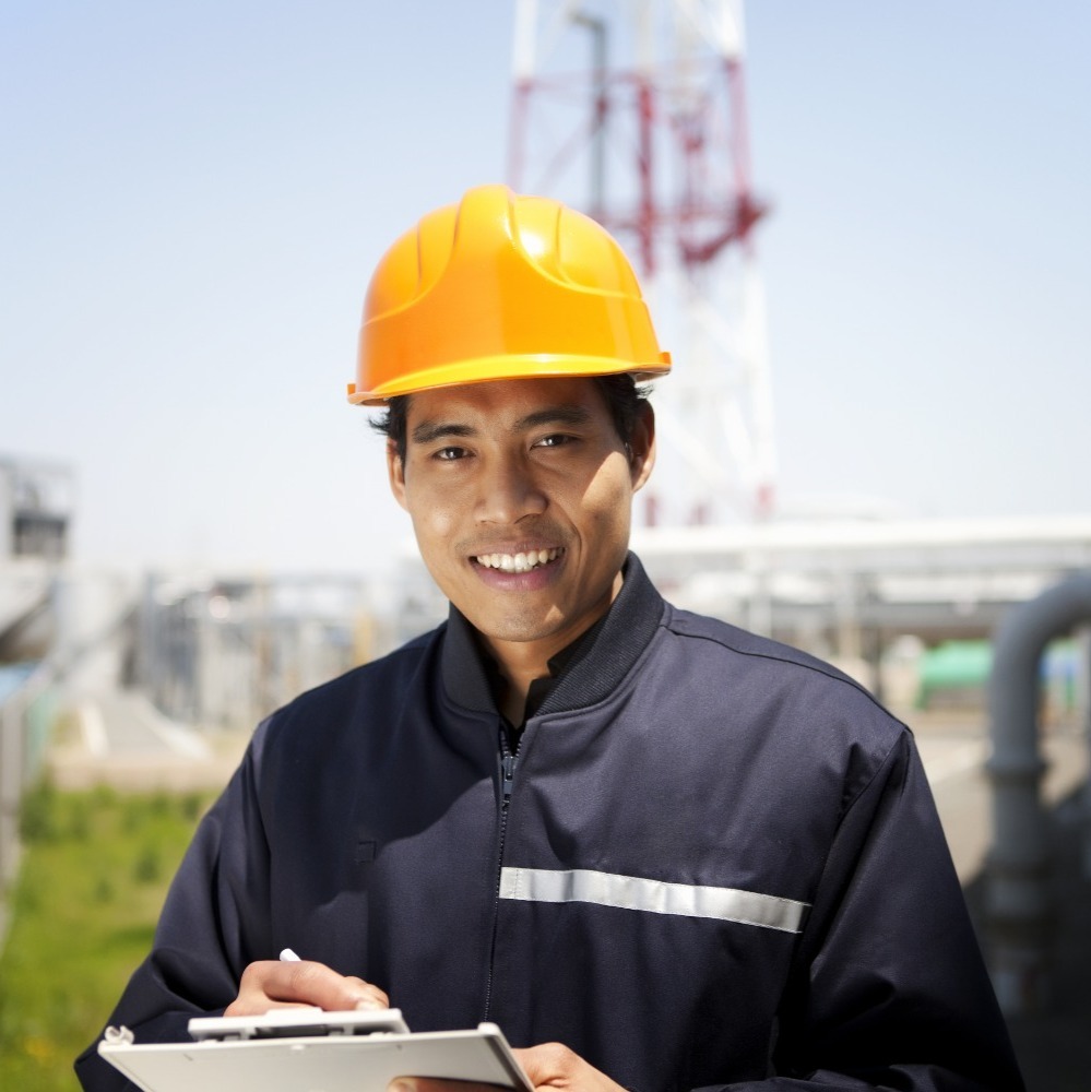 lady wearing a yellow hard hat, smiling