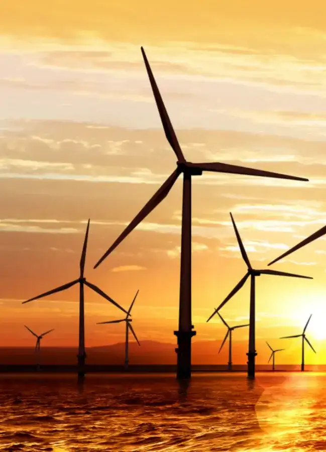 wind turbines in the ocean with sunset background