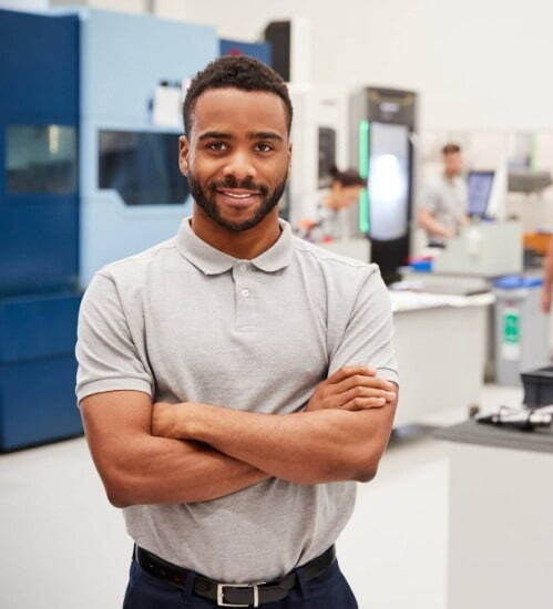 Man stood smiling with his arms folded