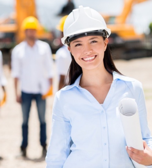 women wearing white hard hat smiling