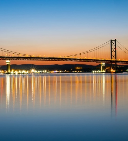 picture of a bridge over water at night