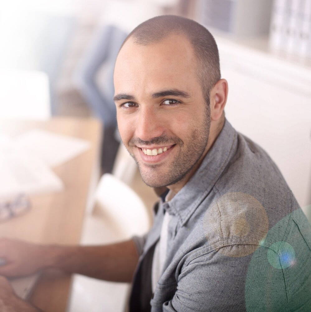 picture of a man sat down, smiling