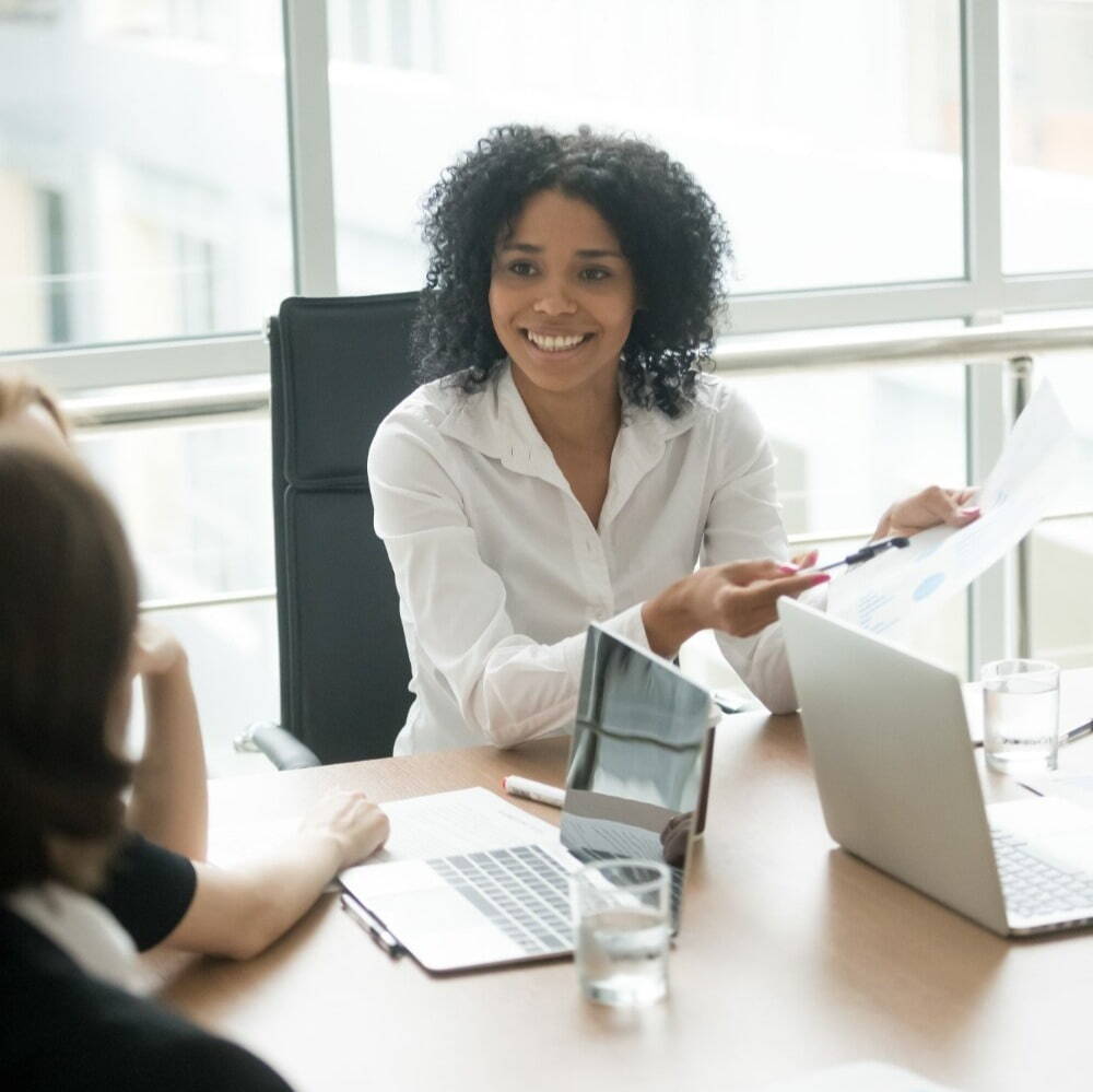 woman at a desk having a meeting, smiling